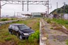 overgrown railroad tracks, relatively pristine car