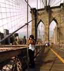 Scenery on the bridge: downtown through the mesh of cables... and the photo gal